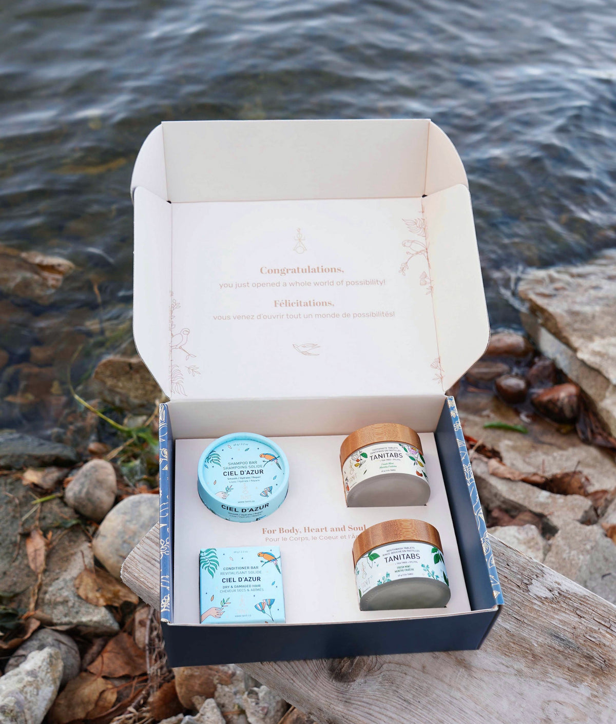Open box with skincare products by a body of water