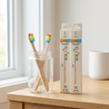 Rainbow kids bamboo toothbrushes in a jar on a bathroom counter